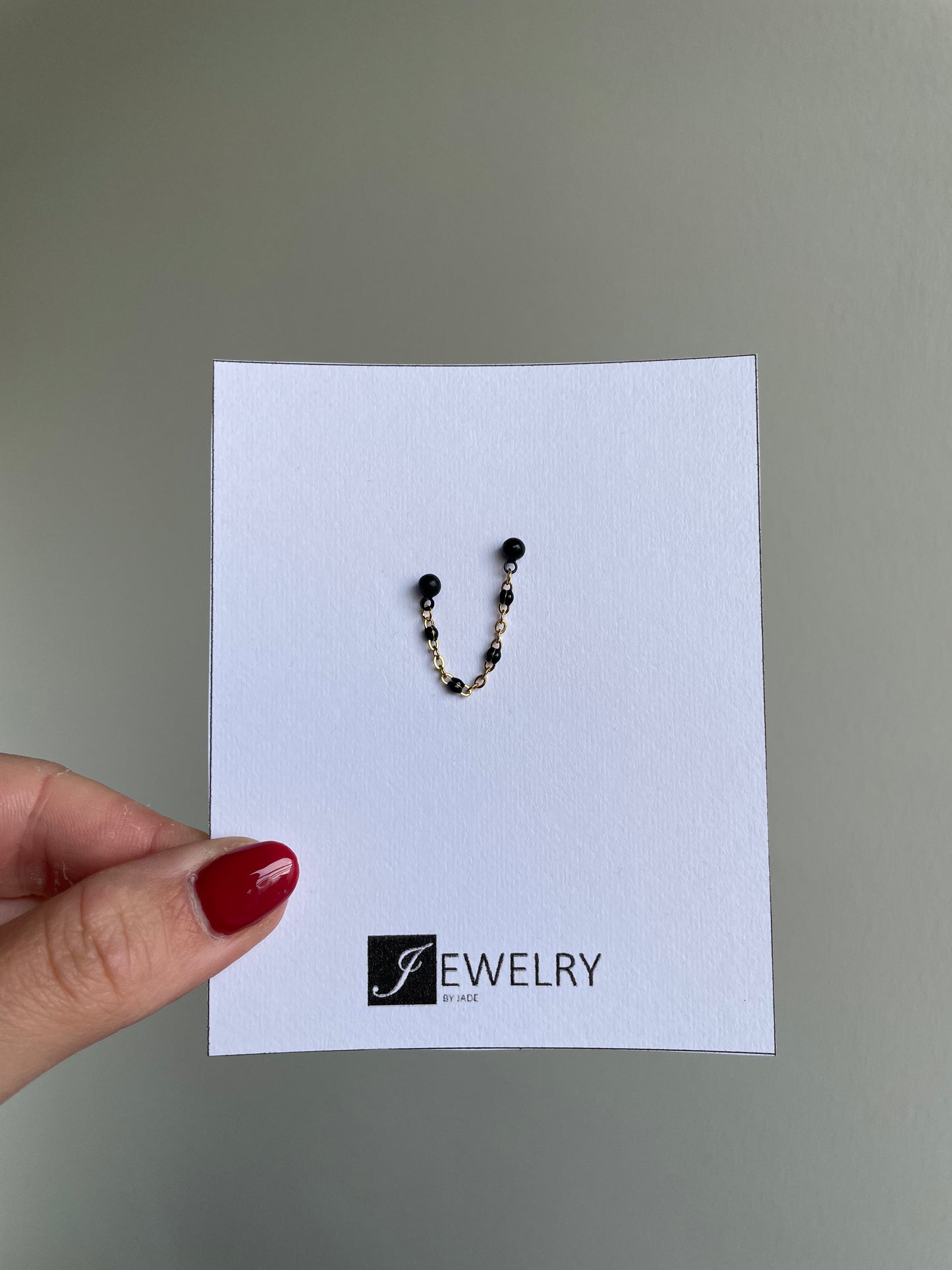 The black connected earring